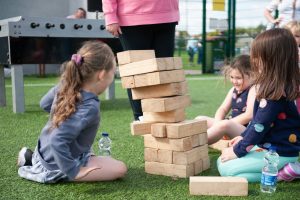 A group children are playing Giant Jenga game as part of a family fun day outdoor event in Cork