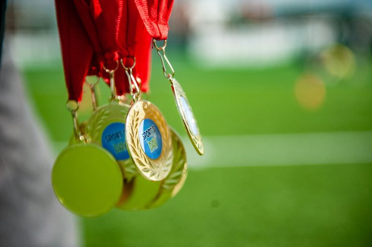 Some medals are dangling in the sun, ready to be presented to the kids who are taking part in a family fun day summer party in Kilkenny