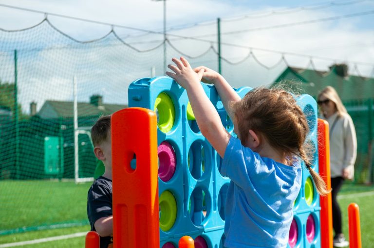 two children are having fun playing giant Connect Four game at a family fun day summer party event in Kilkenny