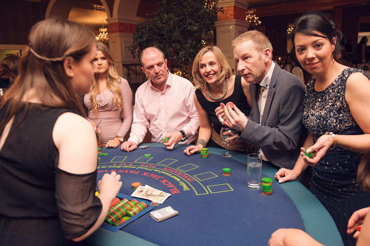 gambling at the blackjack tables at a fun casino night themed event