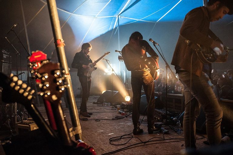 a rock band on stage at a music festival in Ireland