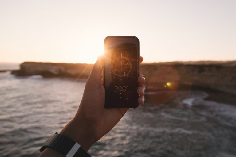 man holding a smartphone searching for an events management company